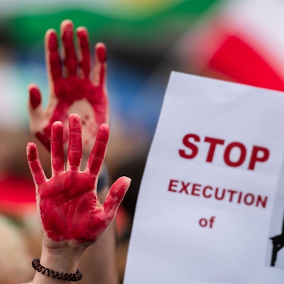 Menschen nehmen am „Marsch für die Freiheit“ teil und haben sich die Hände rot angemalt. Auf einem Plakat wird das Ende von Hinrichtungen gefordert.