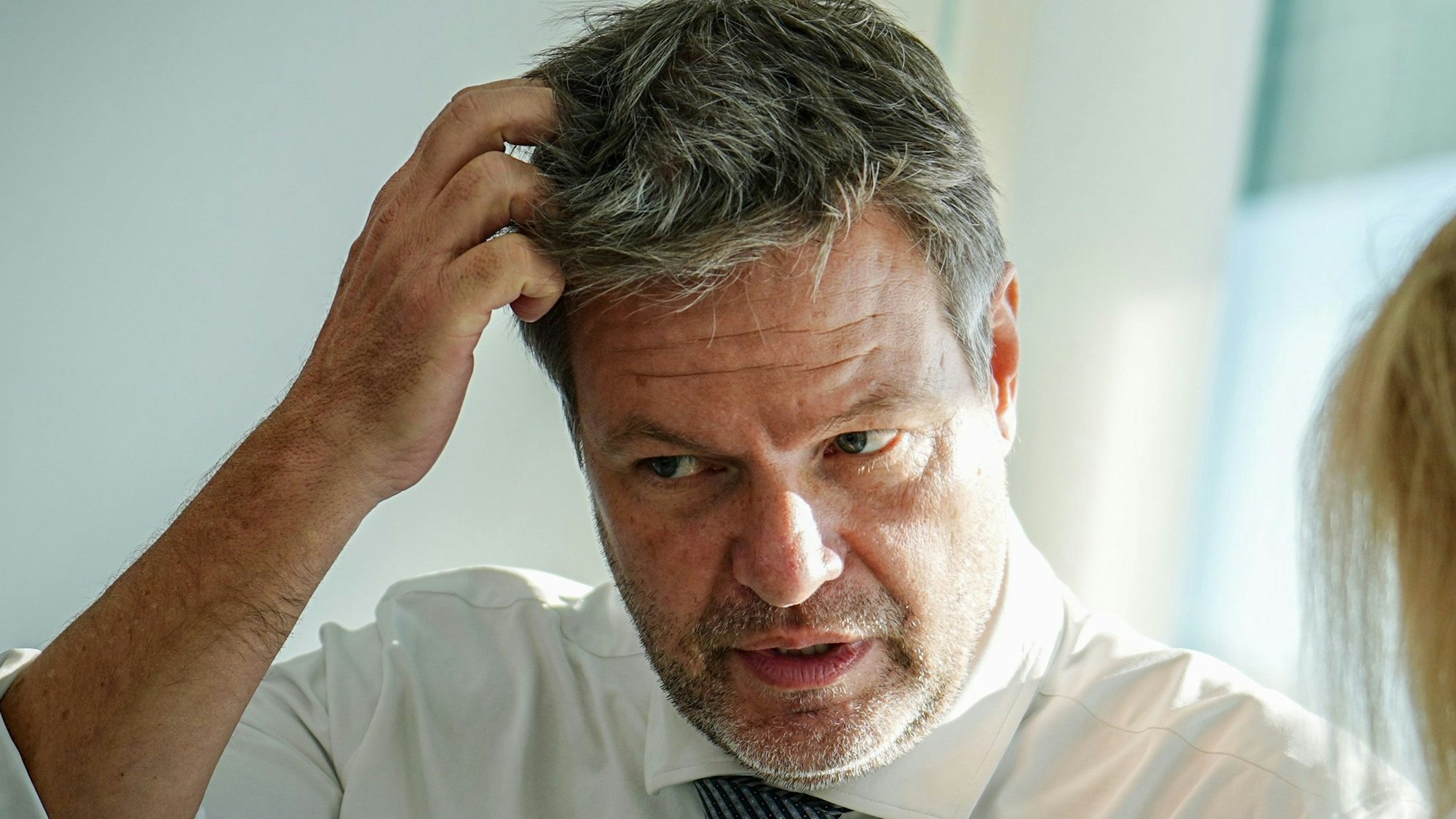 Bundeswirtschaftsminister Robert Habeck (Bündnis 90/Die Grünen) kratzt sich am Kopf und diskutiert mit Innenministerin Nancy Faeser (SPD).