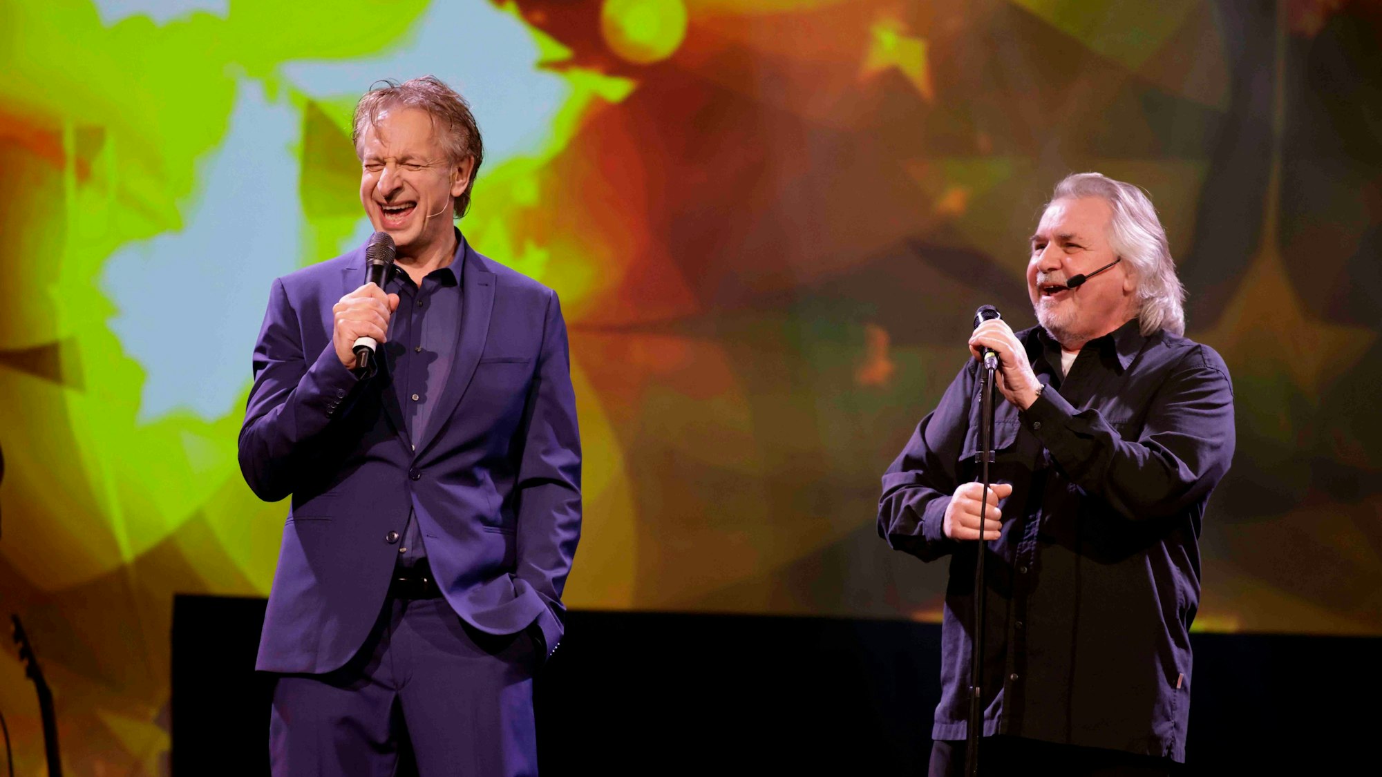Musiker Tommy Engel und Moderator und Komiker Ingolf Lück stehen gemeinsam auf der Bühne.