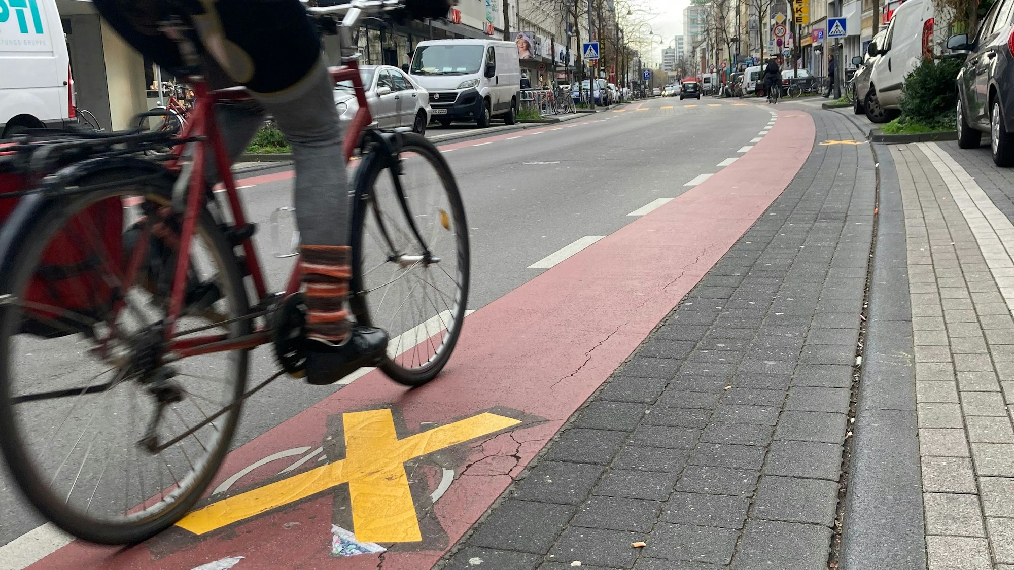 Eine Fahrradfahrerin fährt auf der durchgestrichenen Fahrradspur auf der Venloer Straße.