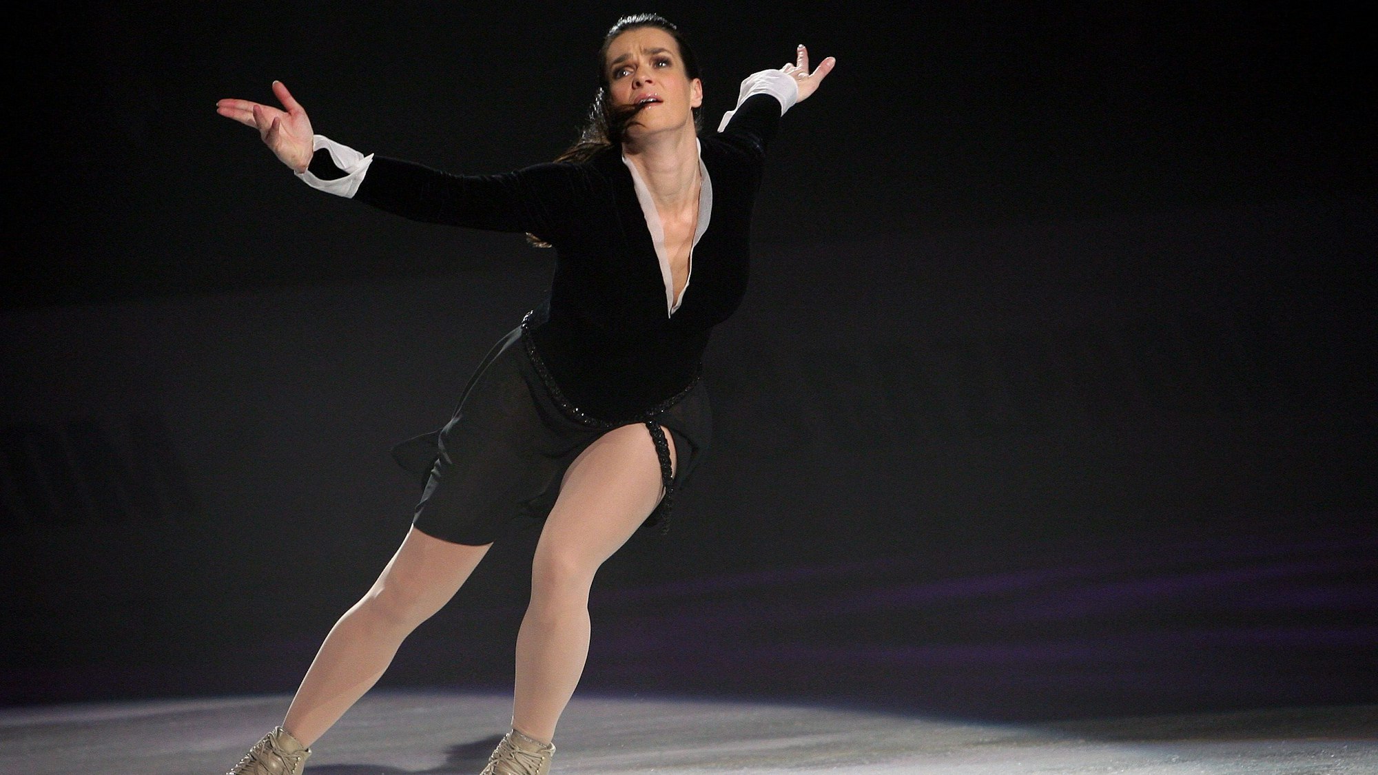 Die Eiskunstläuferin Katarina Witt zeigt am Samstag (16.02.2008) während ihrer Abschieds-Tournee in der Max-Schmeling-Halle in Berlin eine Kür auf dem Eis. Sie hat ihre Arme weit ausgestreckt und schaut gequält.