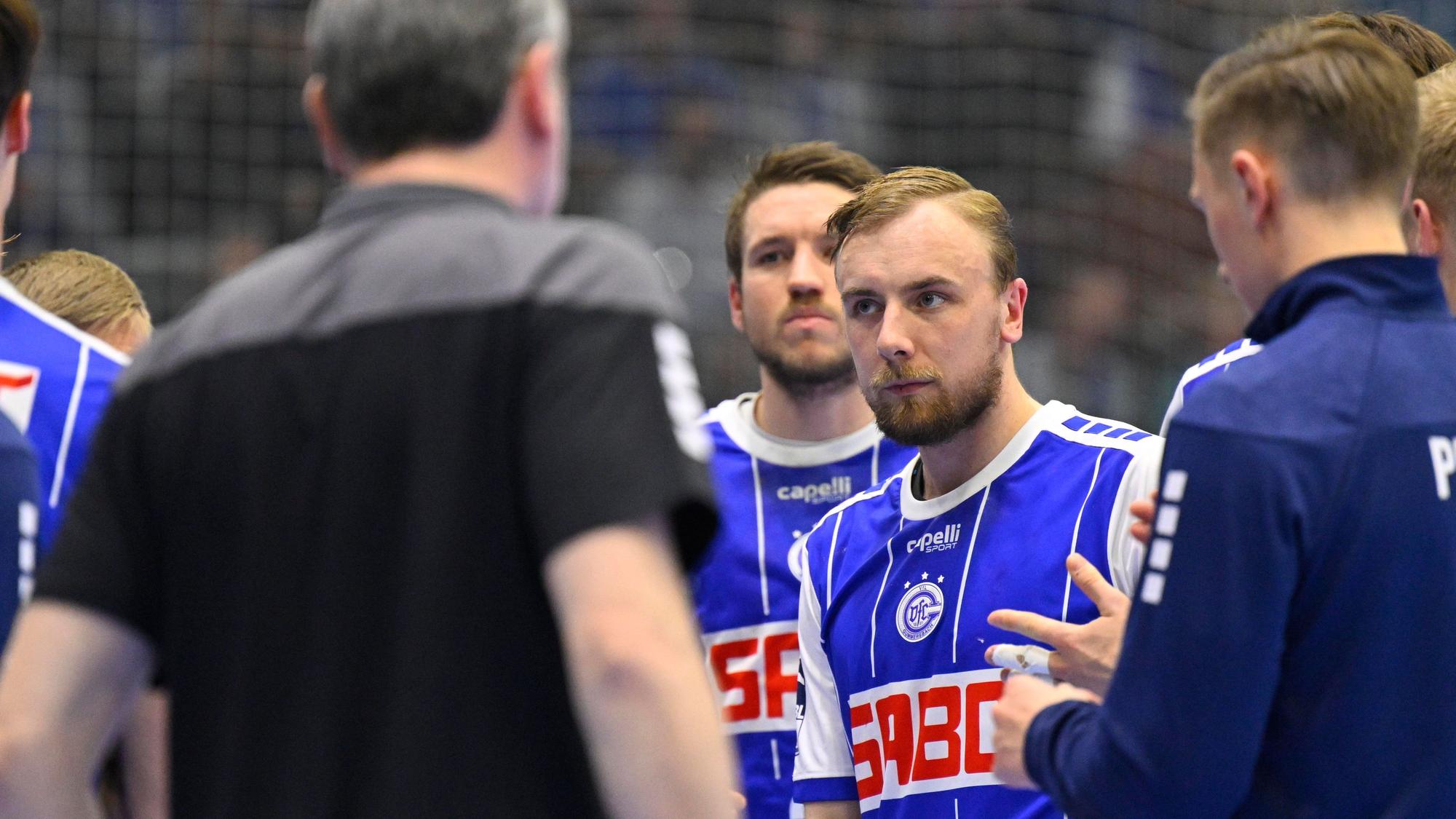 Einige Spieler des VfL Gummersbach stehen i Kreis zusammen, in der Mitte gut zu sehen ist Lukas Blohme.