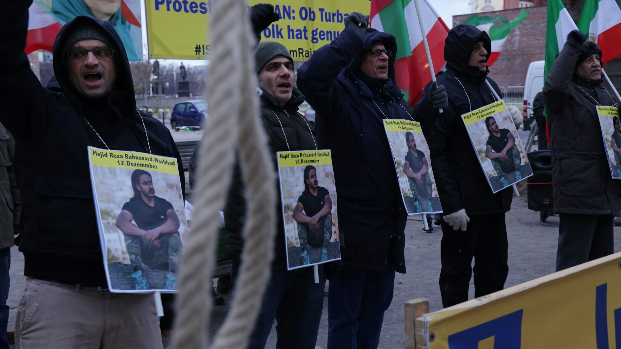 In Berlin protestieren Menschen mit Plakaten gegen die Hinrichtung von Madschid-Resa Rahnavard.