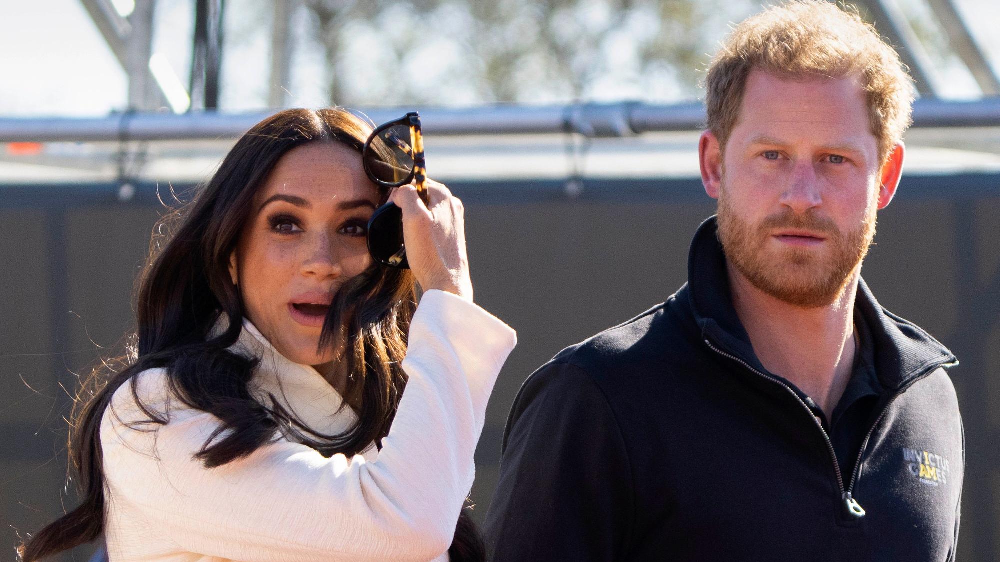 FILE - Prince Harry and Meghan Markle, Duke and Duchess of Sussex visit the track and field event at the Invictus Games in The Hague, Netherlands, Sunday, April 17, 2022. Prince Harry and his wife, Meghan, are expected to vent their grievances against the monarchy when Netflix releases the final episodes of a series about the couple’s decision to step away from royal duties and make a new start in America. (AP Photo/Peter Dejong, File)
