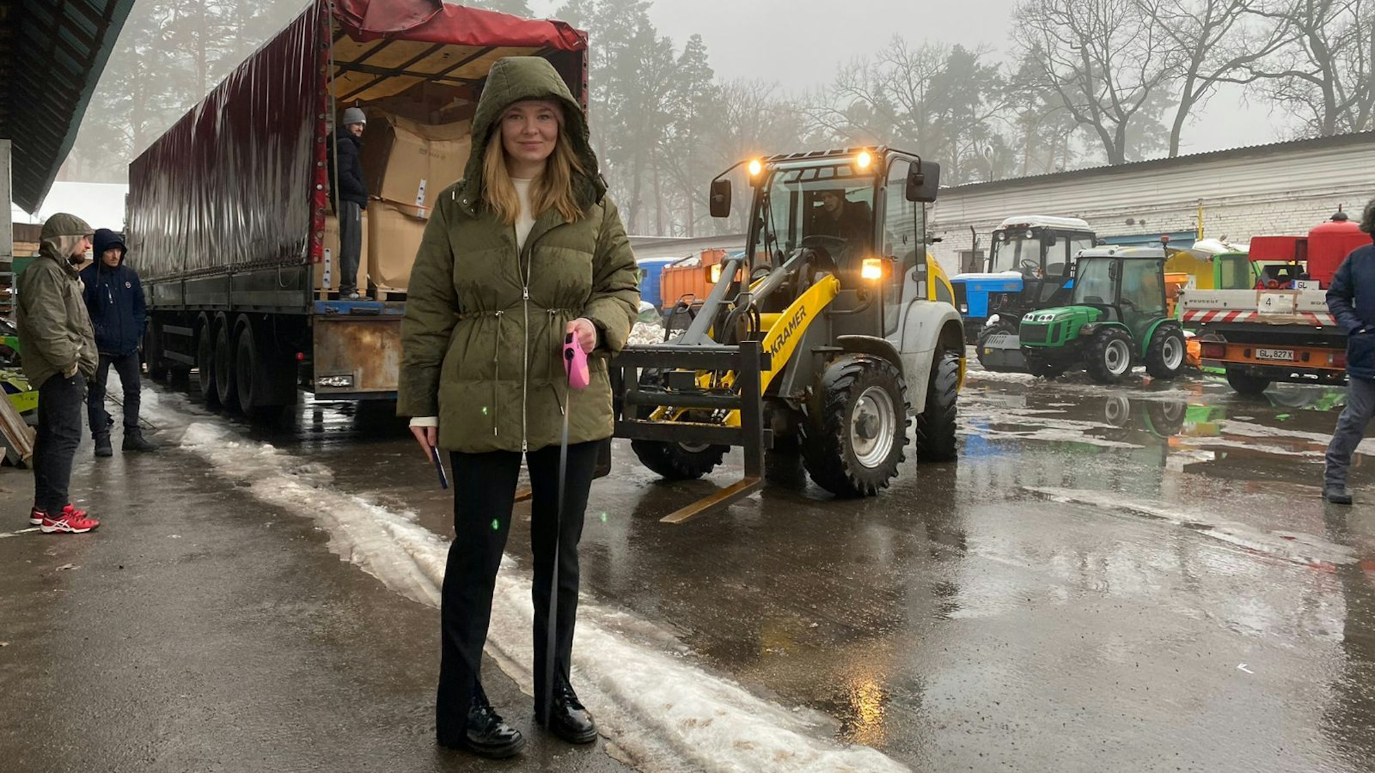 Eine Frau steht im Regen von Butscha, dahinter der Lkw mit den Hilfsgütern aus Bergisch Gladbach.