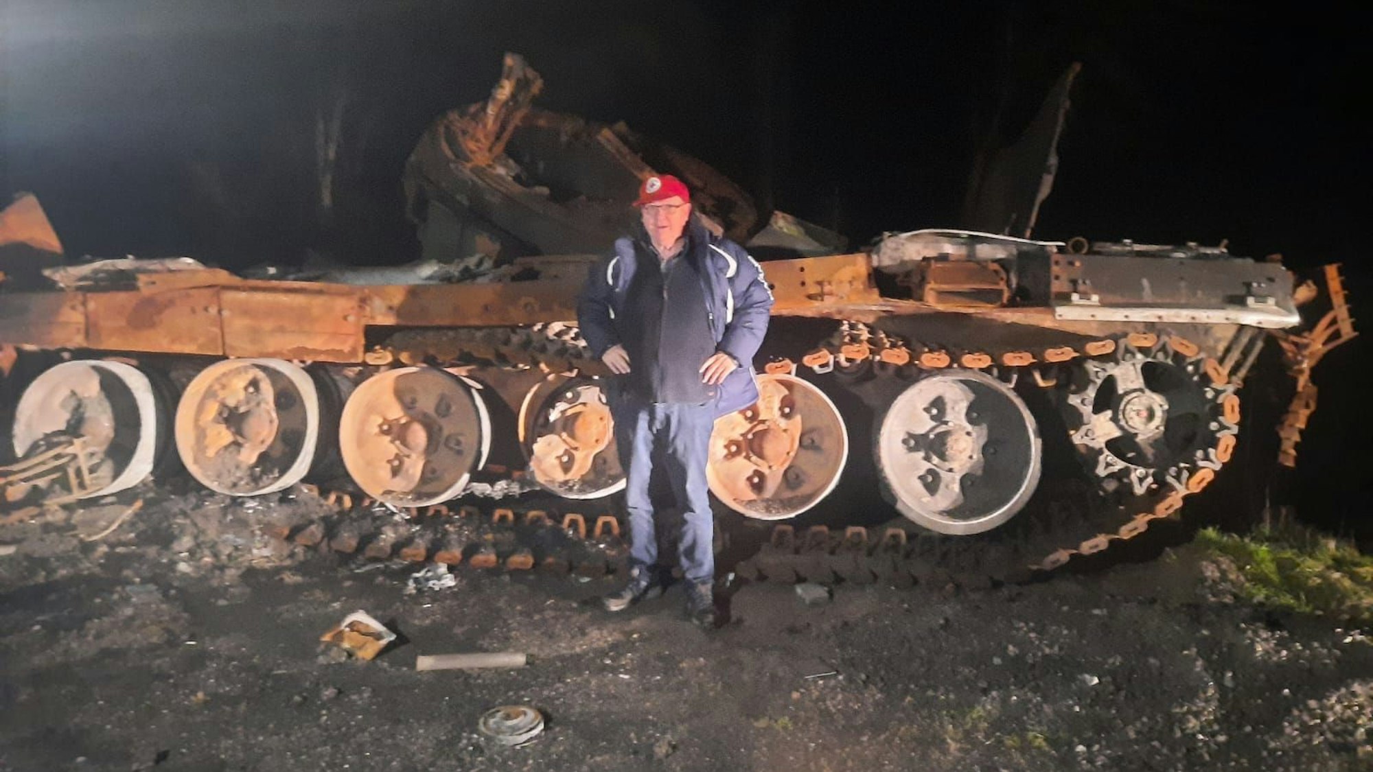 Der Vorsitzende von „Rheinbach Hilft“ steht vor einem Panzerwrack