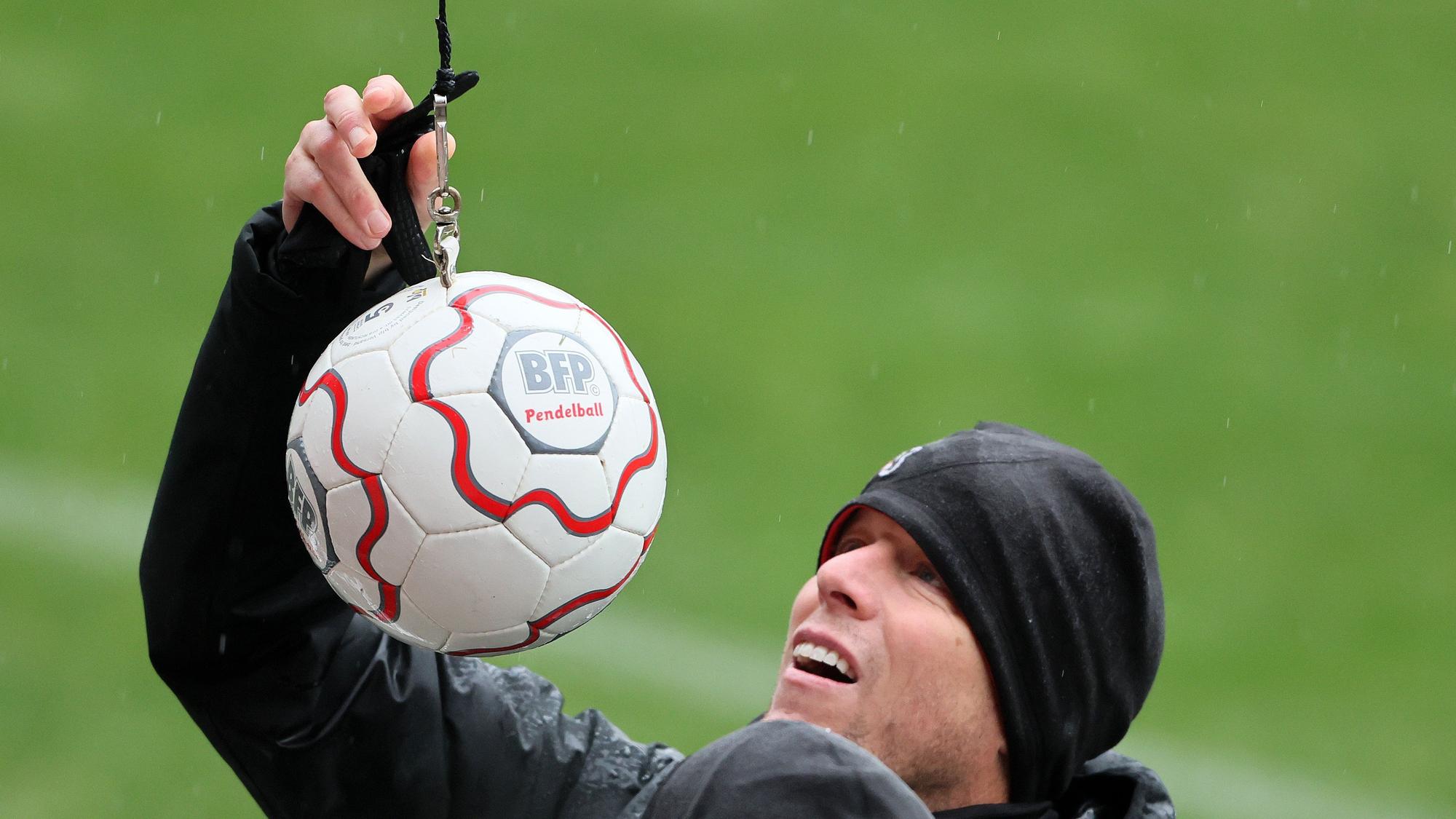 1. FC Köln, Training, Kevin McKenna befestigt einen Pendelball (1. FC Köln), 19.12.2022, Bild: Herbert Bucco