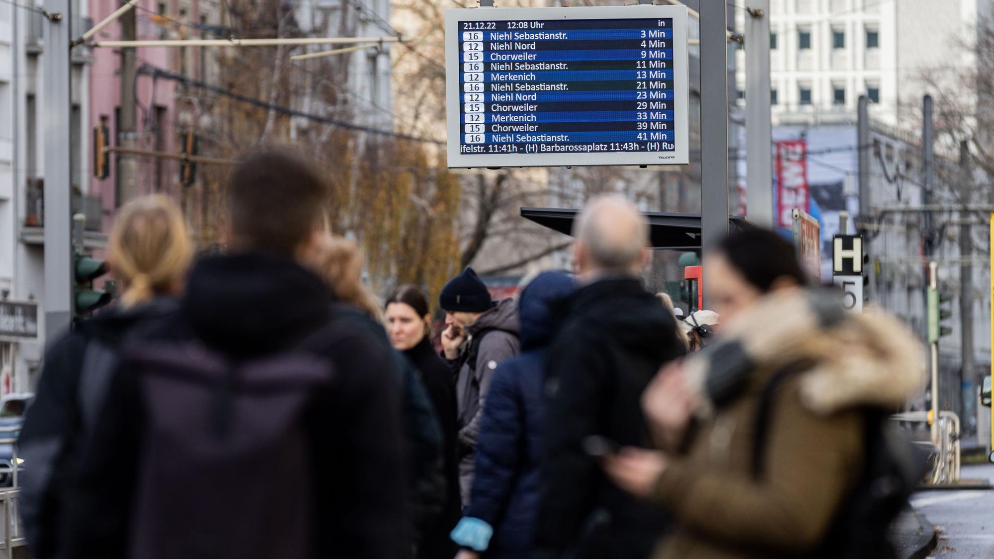 Bahnhaltestelle mit wartenden Menschen.