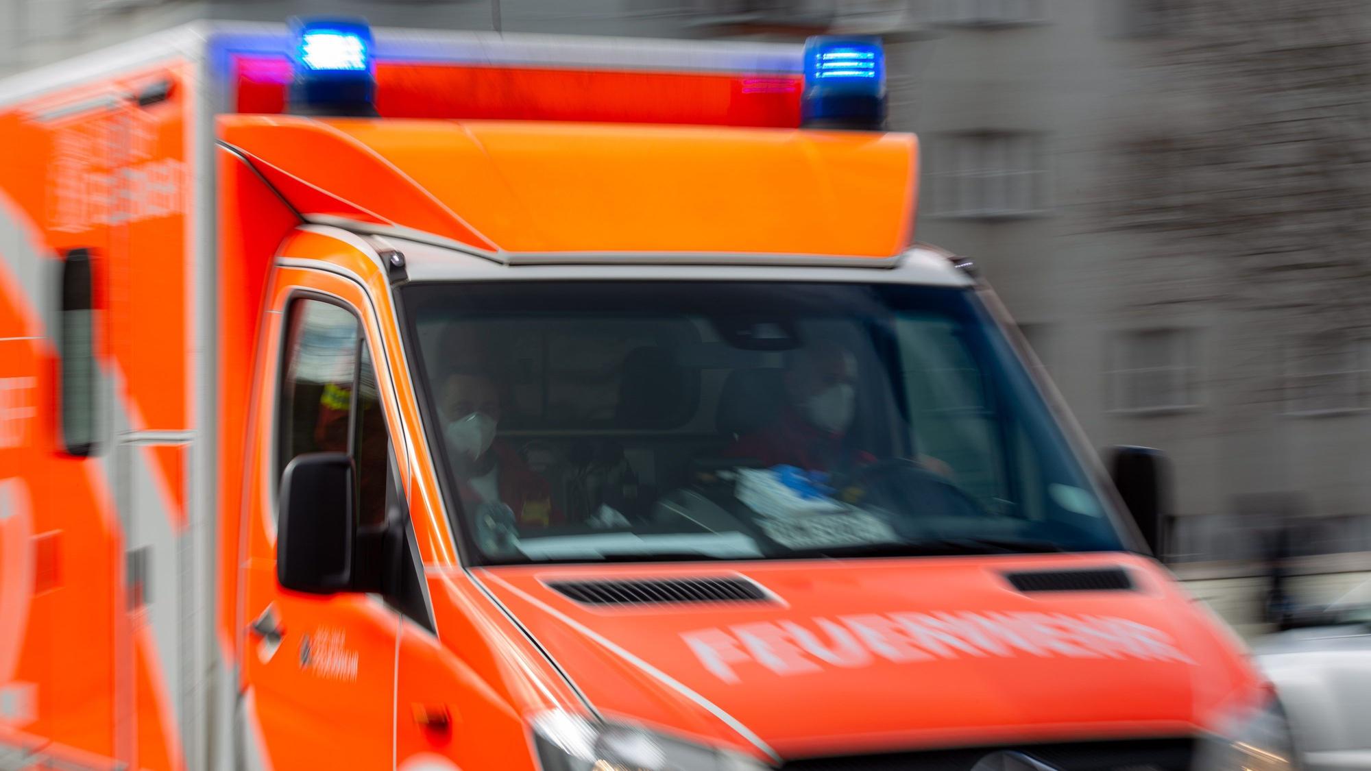Ein Rettungswagen der Feuerwehr fährt auf einer Straße.