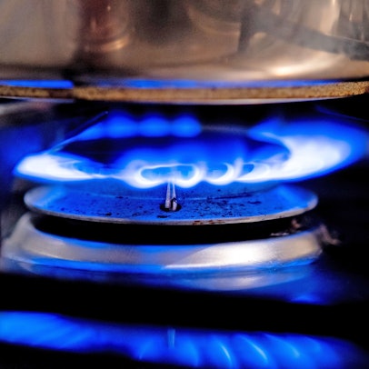 Eine Gasflamme brennt auf einem Küchenherd in einer Wohnung.