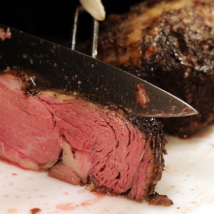 Das Foto zeigt ein Stück Rindfleisch, das aufgeschnitten wird.