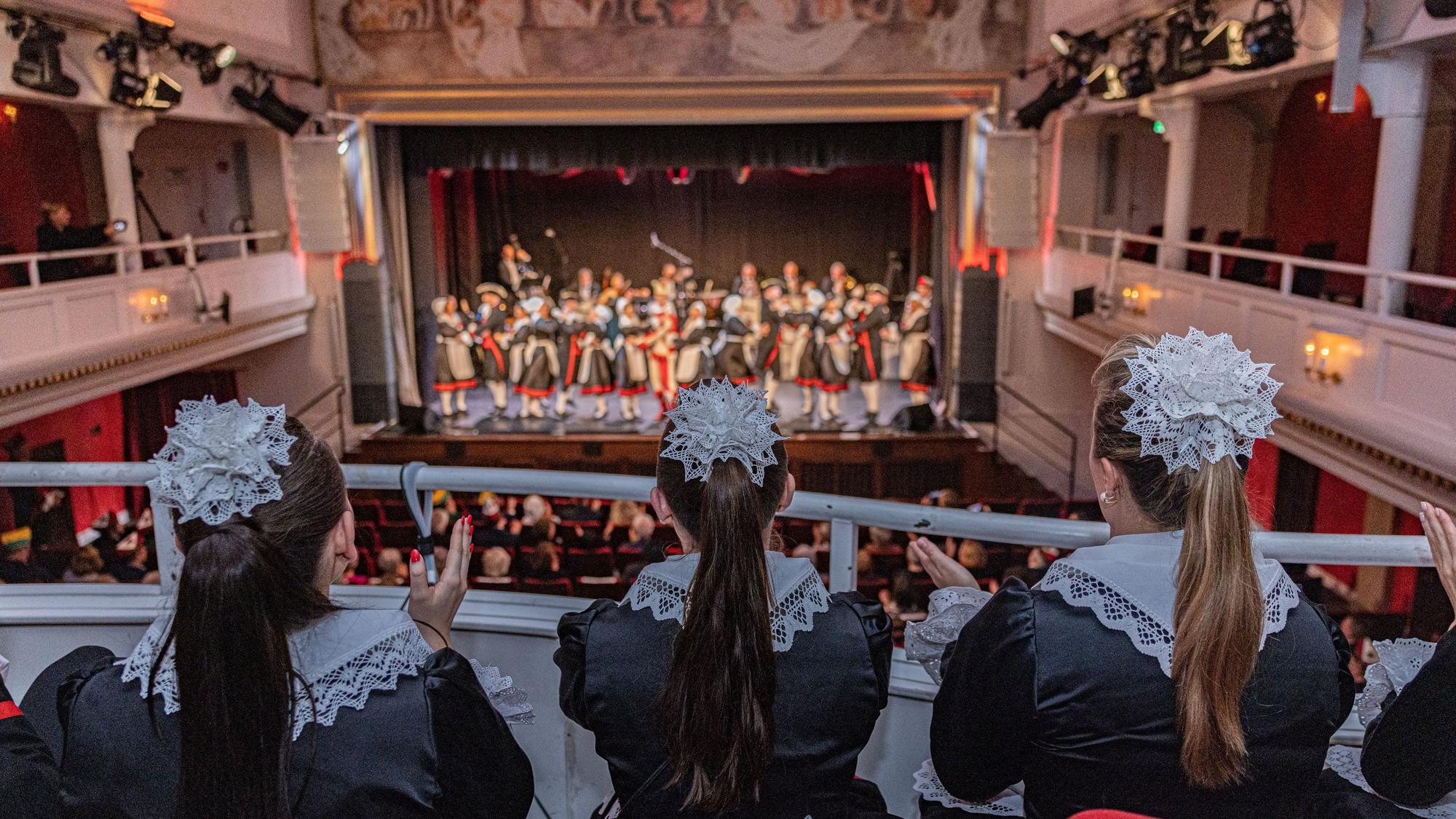 Stilvolles Ambiente: Tänzerinnen der Helligen Knäächte und Mägde verfolgen auf der Tribüne des einstigen Millowitsch-Theaters die Auffürung ihrer Kolleginnen und Kollegen.