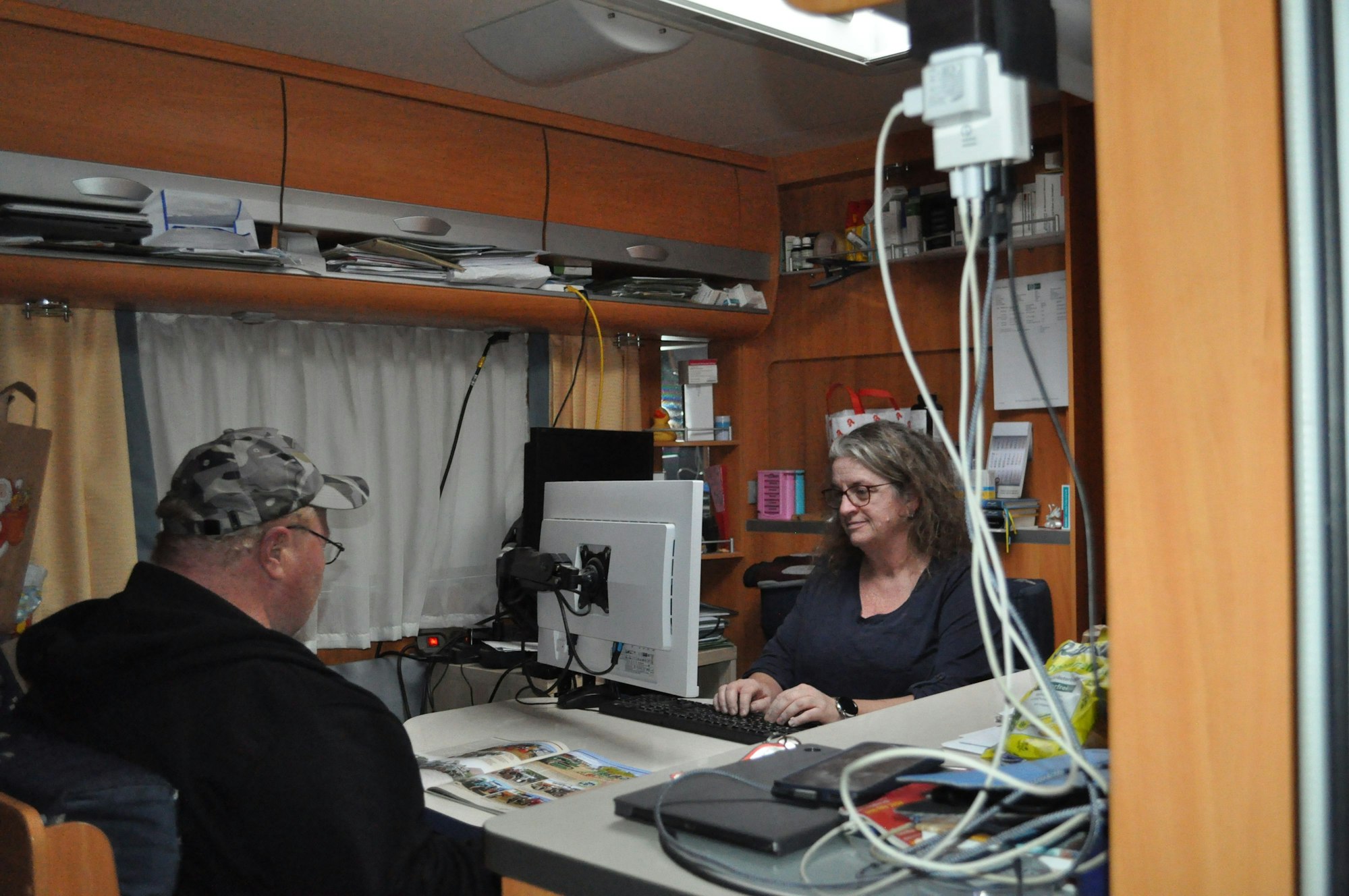 Im Wohnwagen arbeitet Kirsten Cramer. Er ist ihr Homeoffice, ihr Mann schaut Prospekte für den nächsten Campingurlaub.