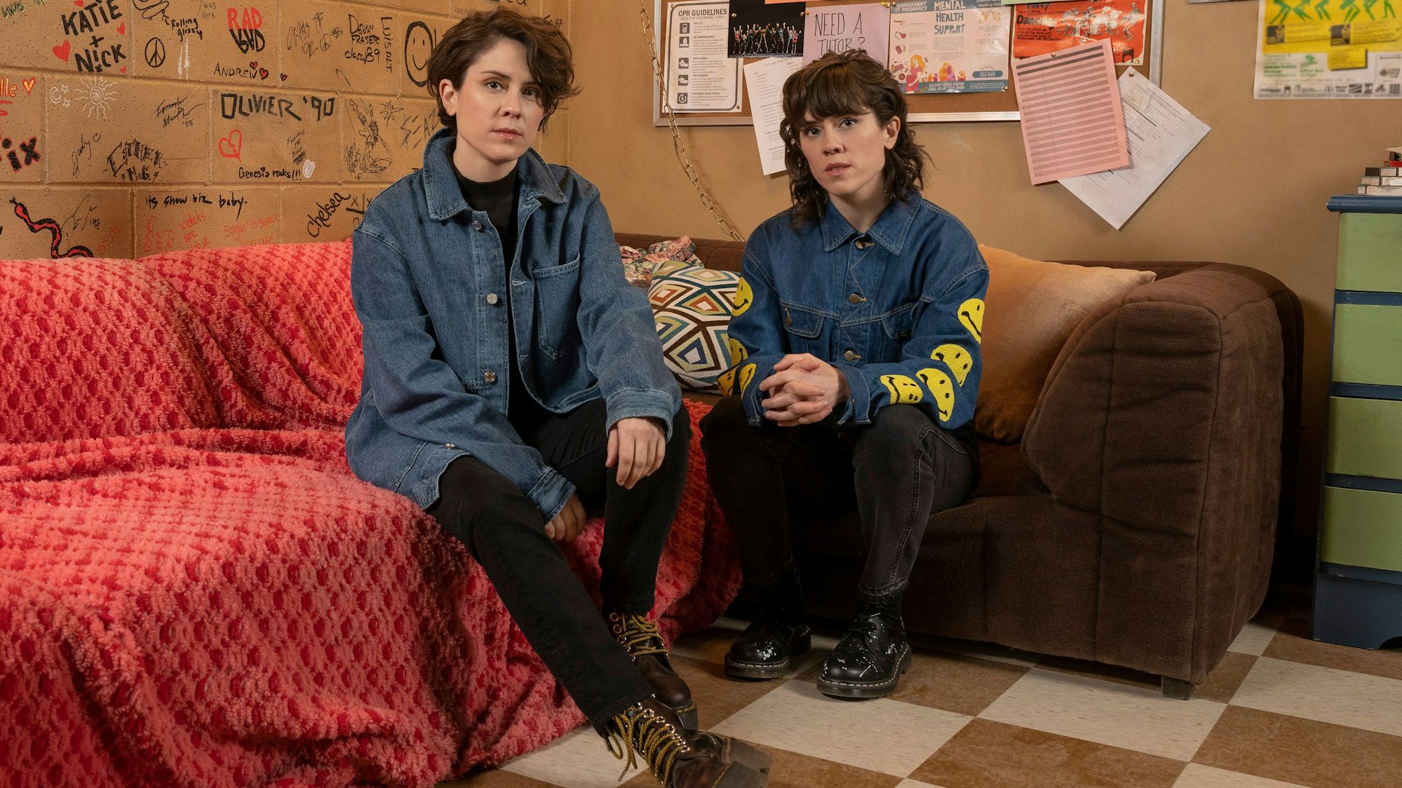 Die Musikerinnen Tegan und Sara sitzen auf einem Sofa
