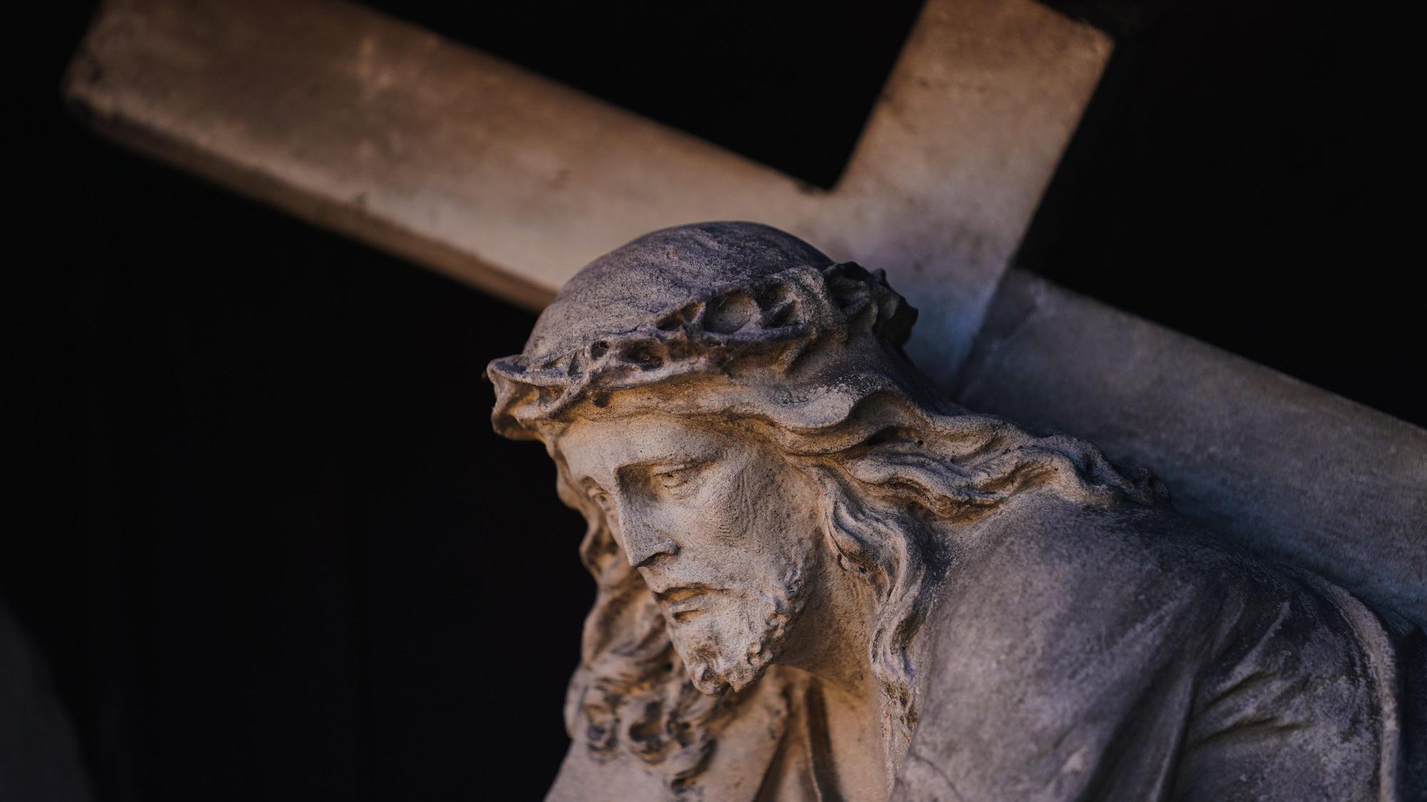 Eine Figur des Jesus Christus mit dem Kreuz ist an einer Fassade in der Altstadt zu sehen.