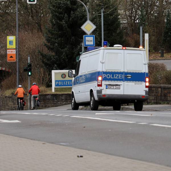 Ein Polizeifahrzeug steht vor der Zufahrt zur Bergisch Gladbacher Kreispolizeibehörde.