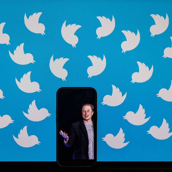 Man sieht einen Bildschirm mit Twitter-Logos, welche alle auf ein Handy mit Musks Bild ausgerichtet sind.