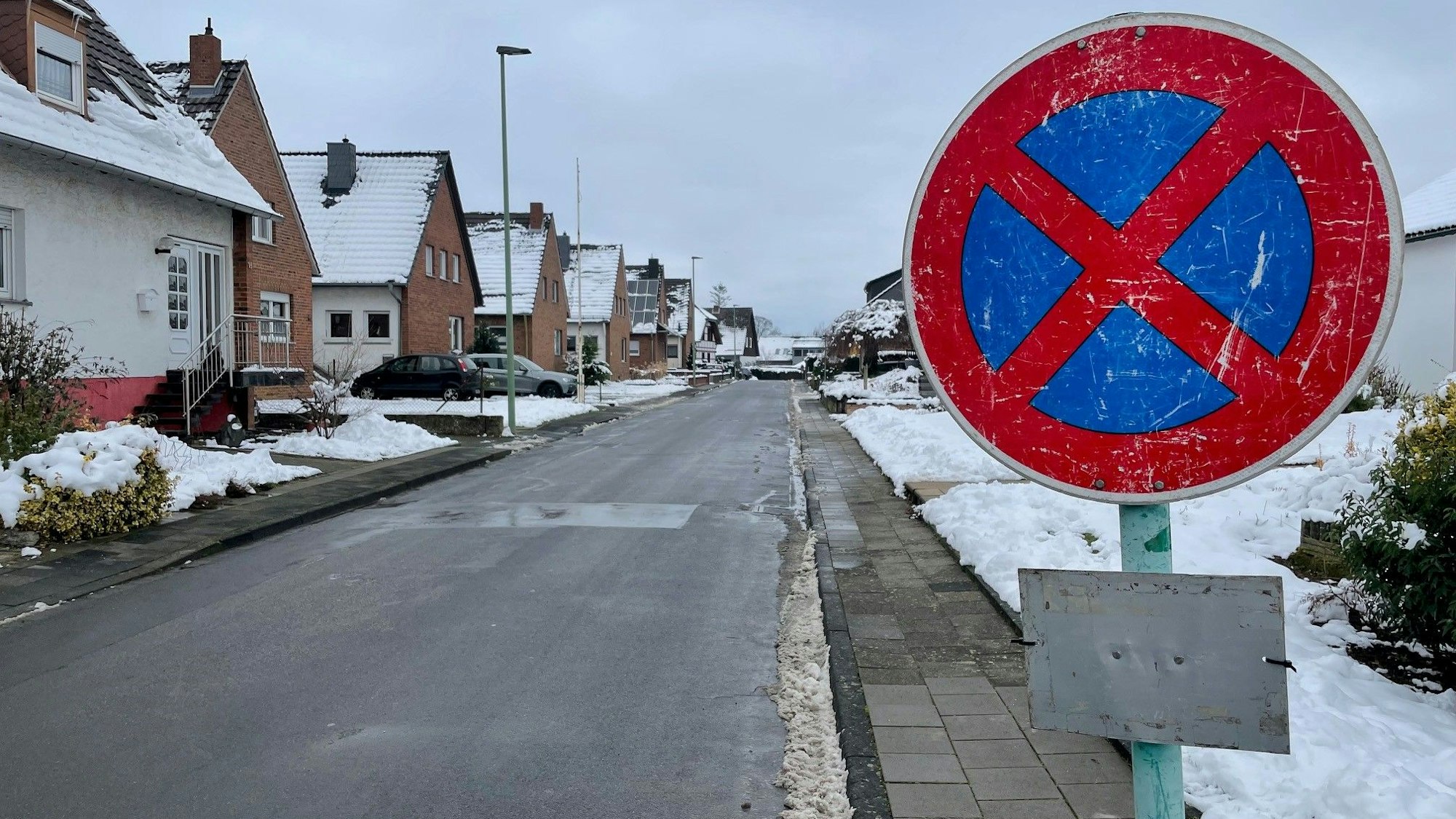 Ein Halteverbotsschild steht auf einem Bürgersteig. Die Stadt hat die Schilder aufgestellt, weil ein Haus droht einzustürzen.