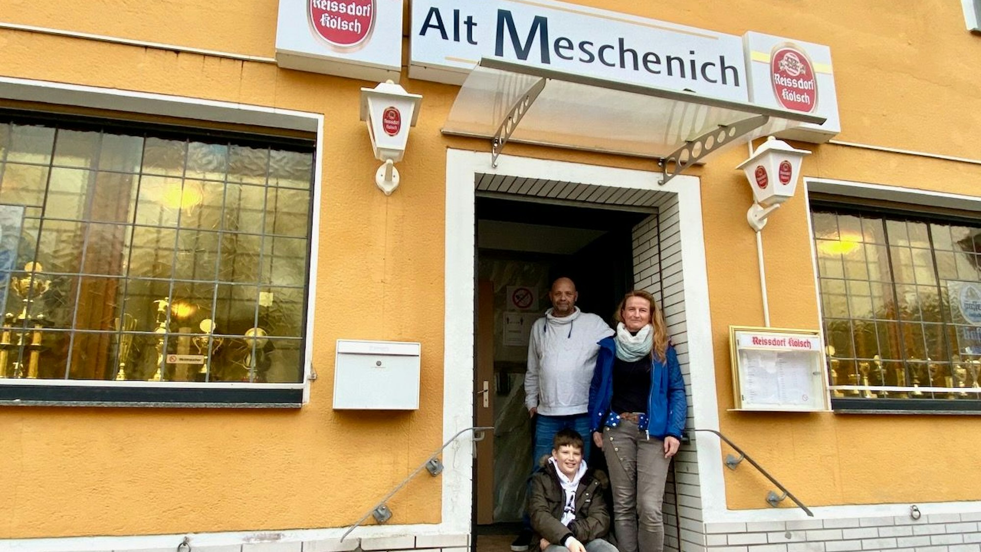Familenportrait vor dem Eingang der Kneipe.