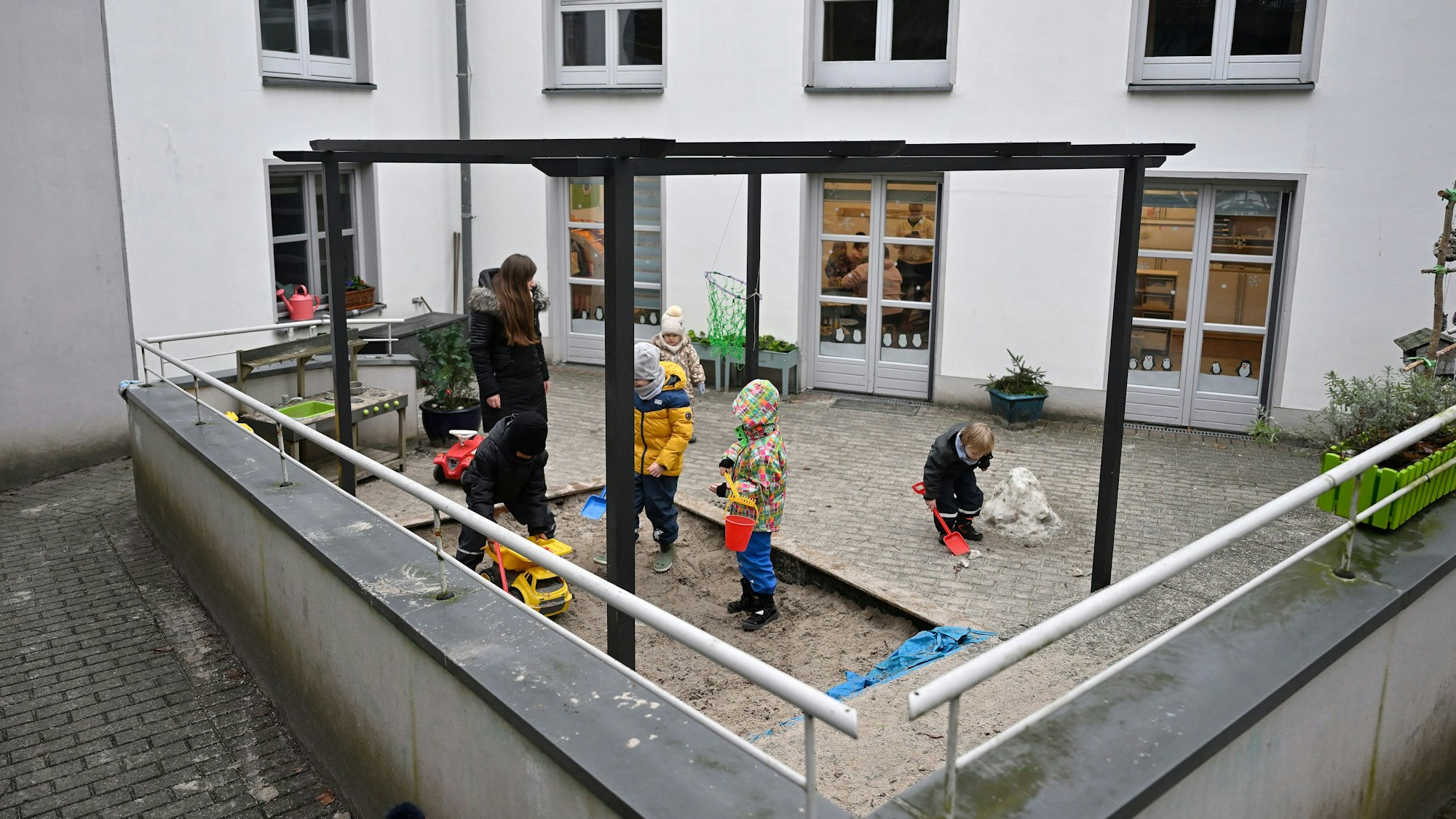 Auf dem Hof der Kita spielen Kinder.