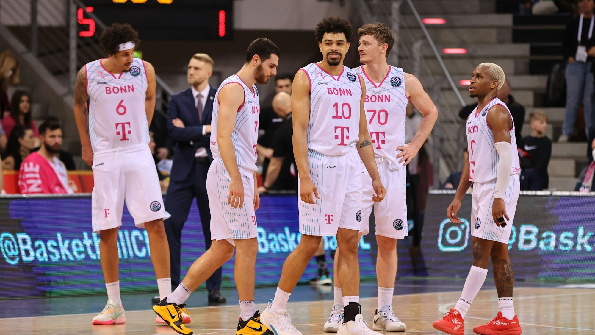 Mehrere Spieler der Telekom Baskets Bonn stehen auf dem Spielfeld.