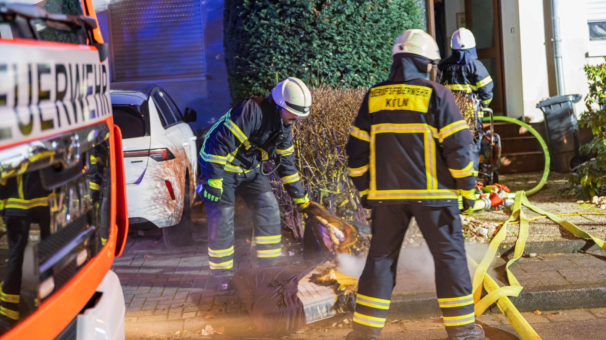 Löscharbeiten vor einem Wohnhaus in Köln-Porz