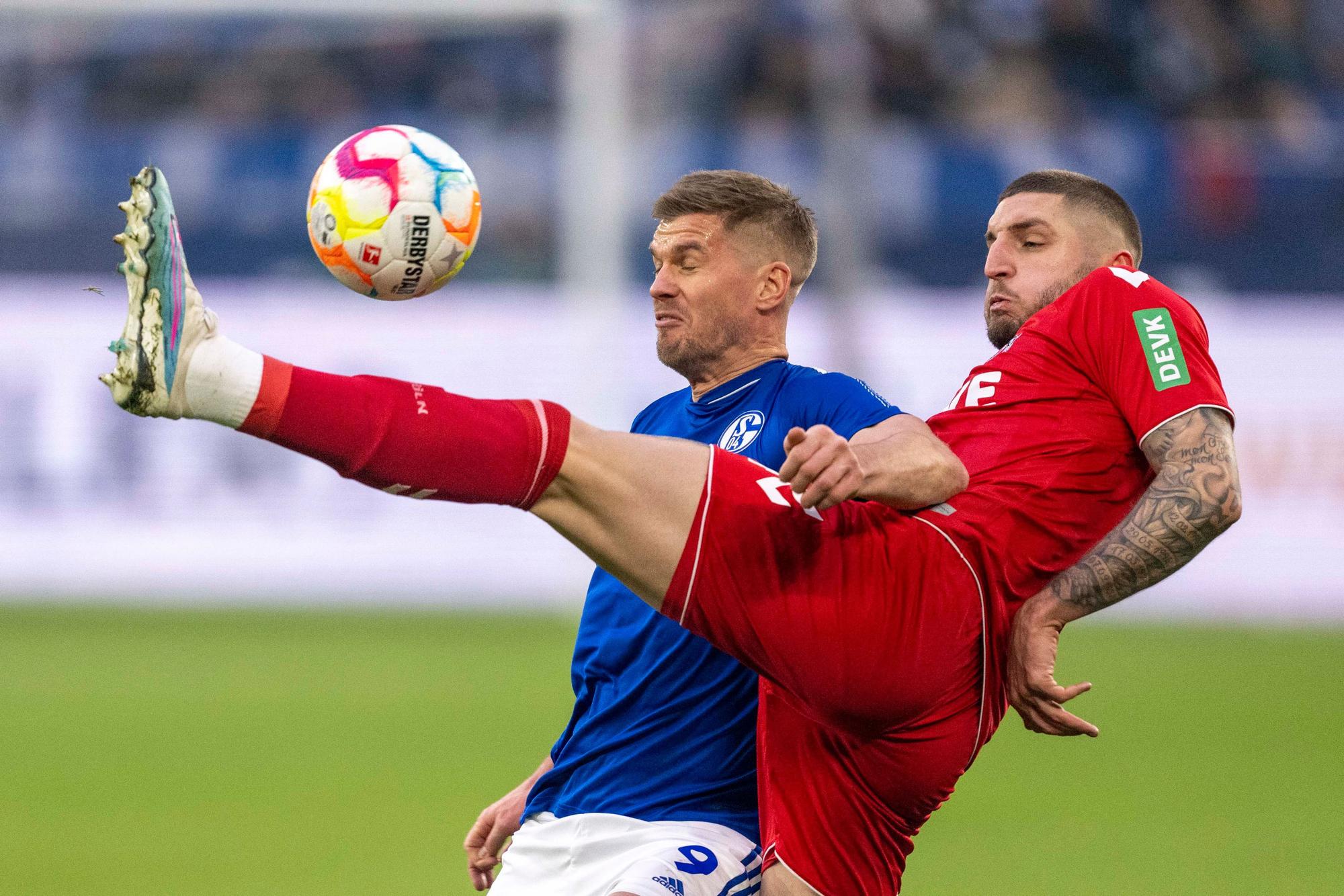 Schalkes Simon Terodde (l) und Kölns Julian Chabot kämpfen um den Ball.