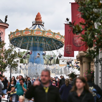 Besucher gehen durch den Freizeitpark Phantasialand.