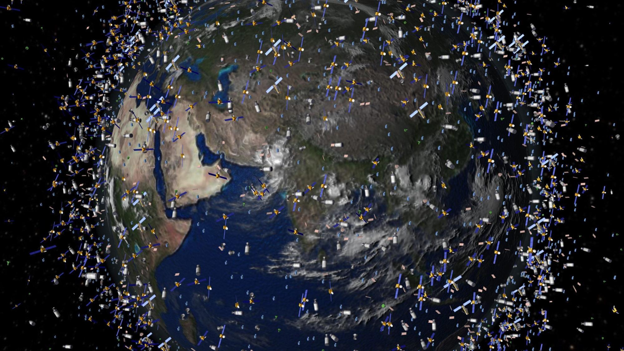 Ein computergeneriertes Bild der European Space Agency (ESA) zeigt Weltraummüll früherer Weltraummissionen, der neben intakten Satelliten um die Erde kreist. (Symbolbild)
