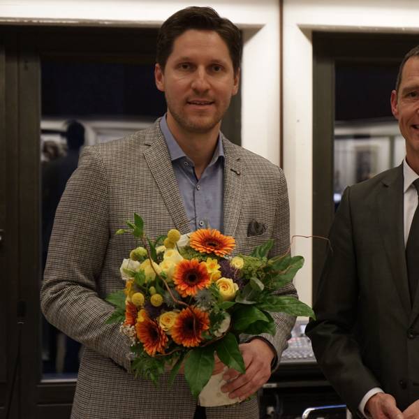 Das Foto zeigt Dominik Laufs (links) mit einem Blumenstrauß nach seiner Wahl zum Ersten Beigeordneten in Frechen. Bürgermeister Dieter Spürck gratulierte ihm.