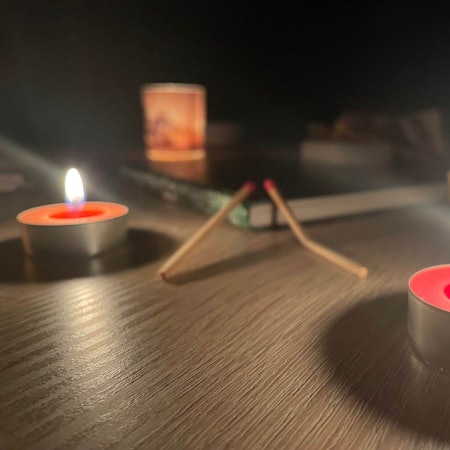 Teelichter und verbrauchte Streichhölzer auf einem Tisch.