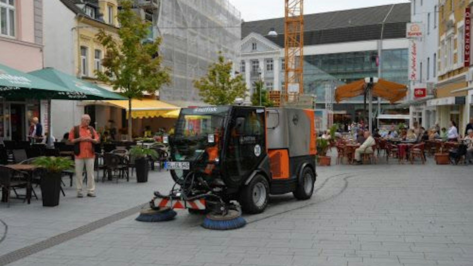 Eine Kehrmaschine säubert das Pflaster der Fußgängerzone in Bergisch Gladbach.