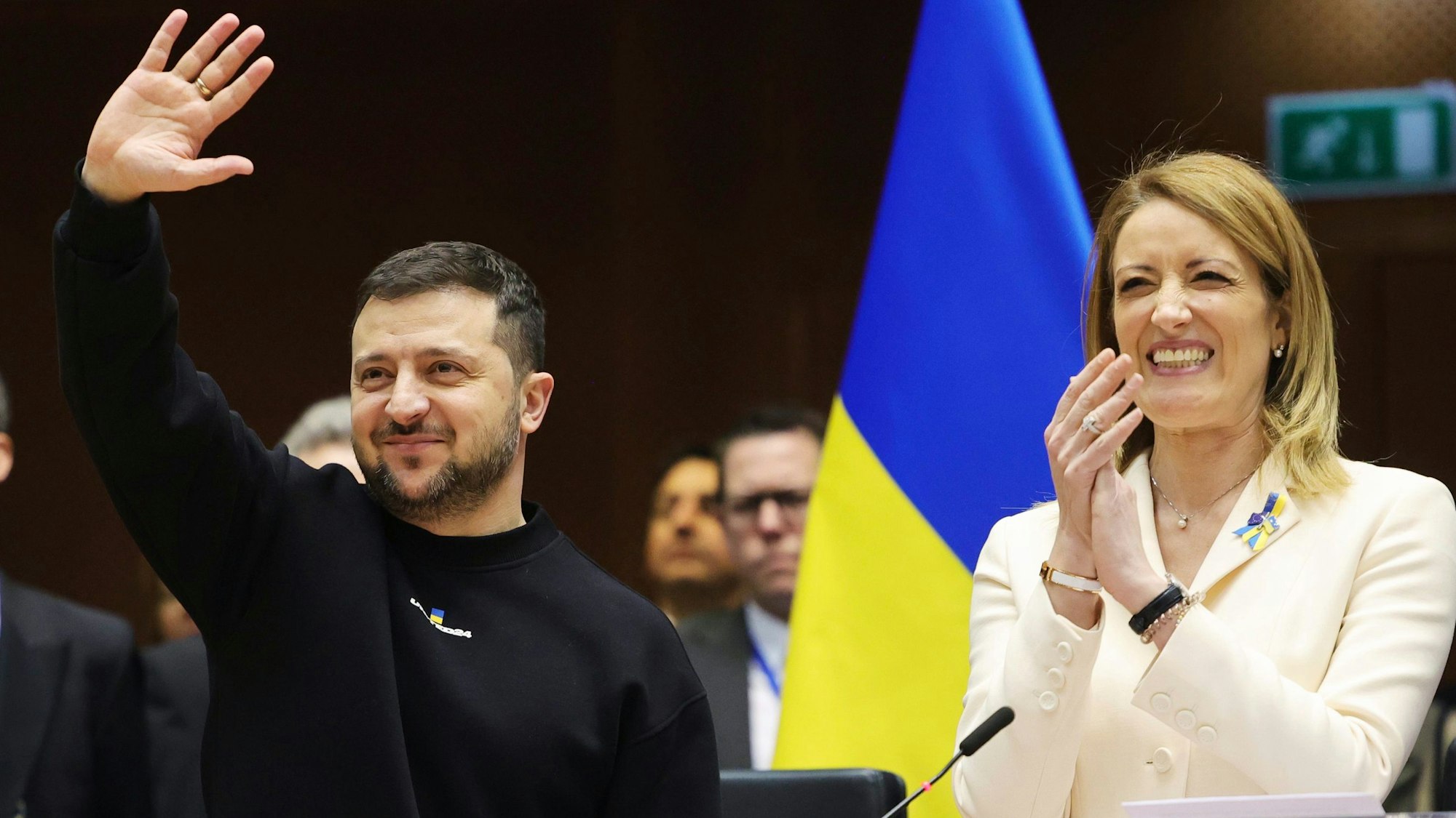 Ukraine's President Volodymyr Zelenskyy, centre, gestures as European Parliament's President Roberta Metsola, right, applauds during an EU summit at the European Parliament in Brussels, Belgium, Thursday, Feb. 9, 2023. On Thursday, Zelenskyy will join EU leaders at a summit in Brussels, which German Chancellor Olaf Scholz described as a "signal of European solidarity and community." (AP Photo/Olivier Matthys)