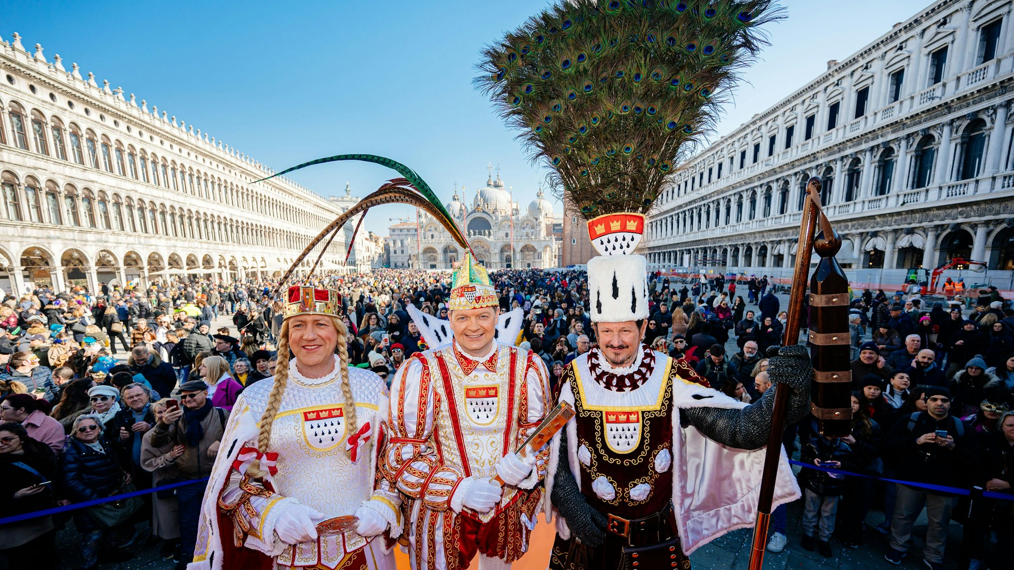 Auftritt auf dem Markusplatz: Das Dreigestirn der Roten Funken grüßt die Feiernden im italienischen Venedig.