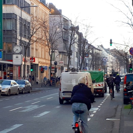 Autos und Radfahrer fahren auf der Neusser Straße.
