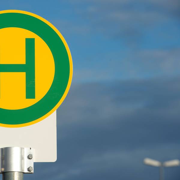 Es ist ein Schild für eine Bushaltestelle zu sehen.
