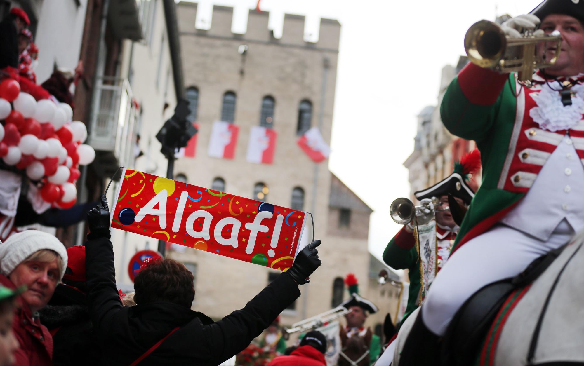 Ein Schild "Alaaf" hält am 11.02.2013 ein Karnevalist an der Zugstrecke in Köln (Nordrhein-Westfalen).