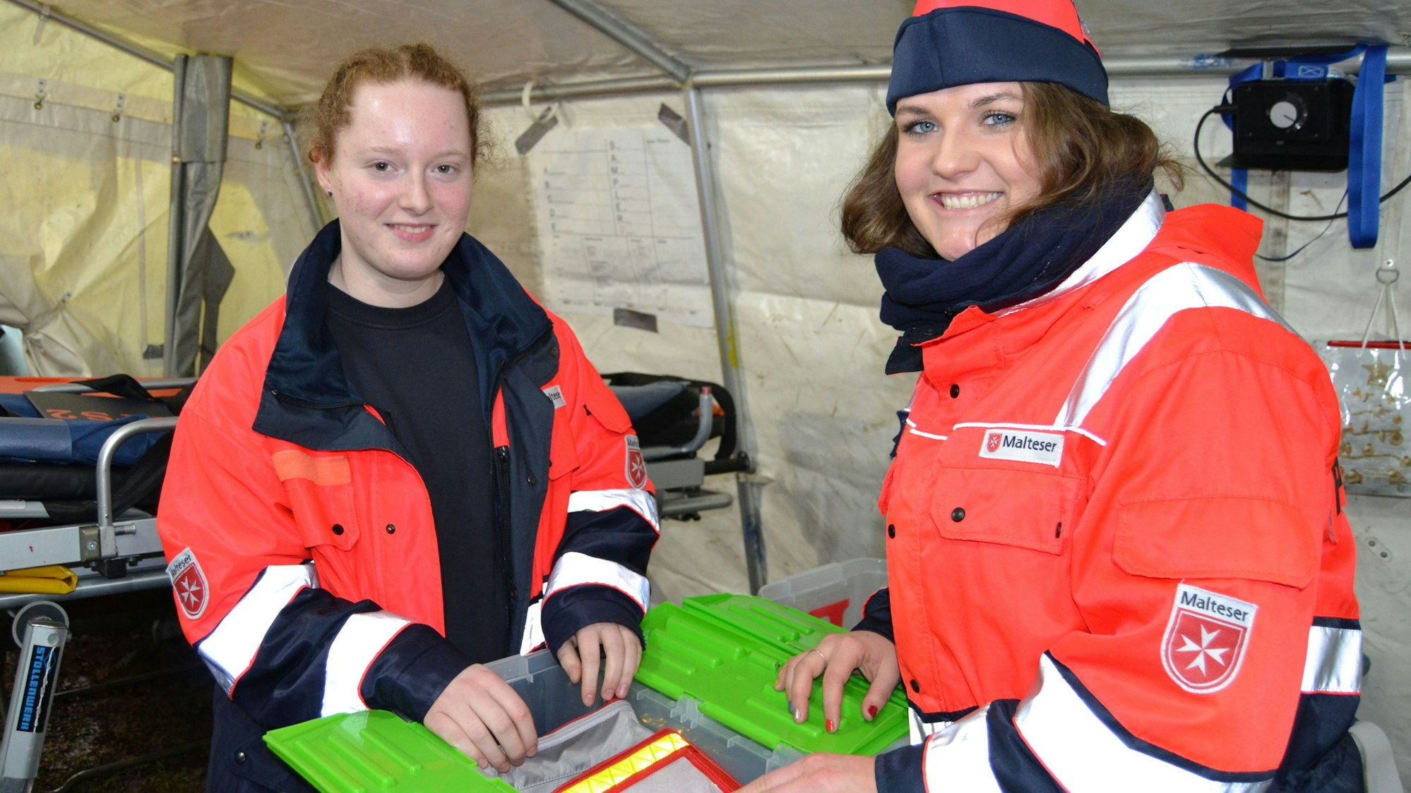 Blick auf zwei Sanitäterinnen, die ihre Ausrüstung prüfen.