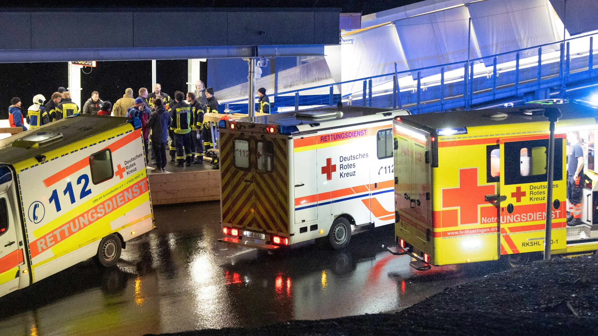 Rettungswagen und Helfer stehen am Ausgang der Bobbahn. Bei einem schweren Unfall auf der Oberhofer Bob- und Rennrodelbahn ist am Donnerstag ein Mensch ums Leben gekommen. Eine weitere Person wurde schwer, zwei weitere leicht verletzt.