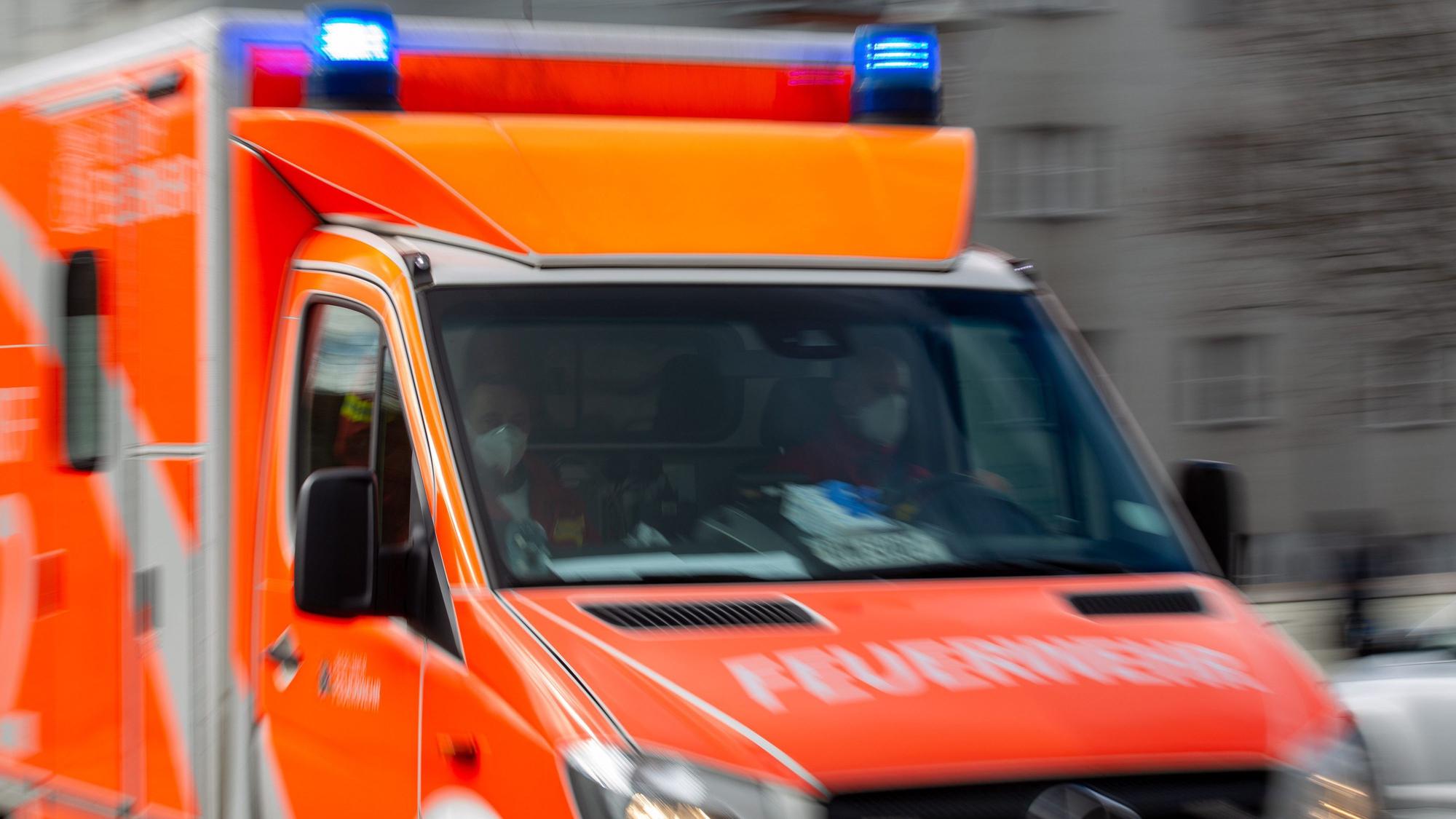 Ein Rettungswagen der Feuerwehr fährt auf einer Straße (Aufnahme mit Langzeitbelichtung). (Symbolbild)