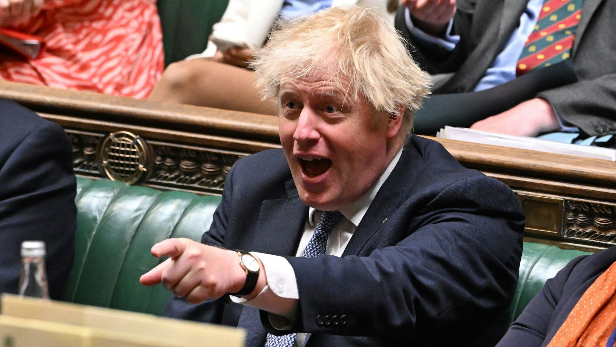 A handout photograph released by the UK Parliament shows Britain's Prime Minister Boris Johnson laughing as Britain's Chancellor of the Exchequer Rishi Sunak makes a statement on the cost of living crisis in the House of Commons on May 26, 2022.