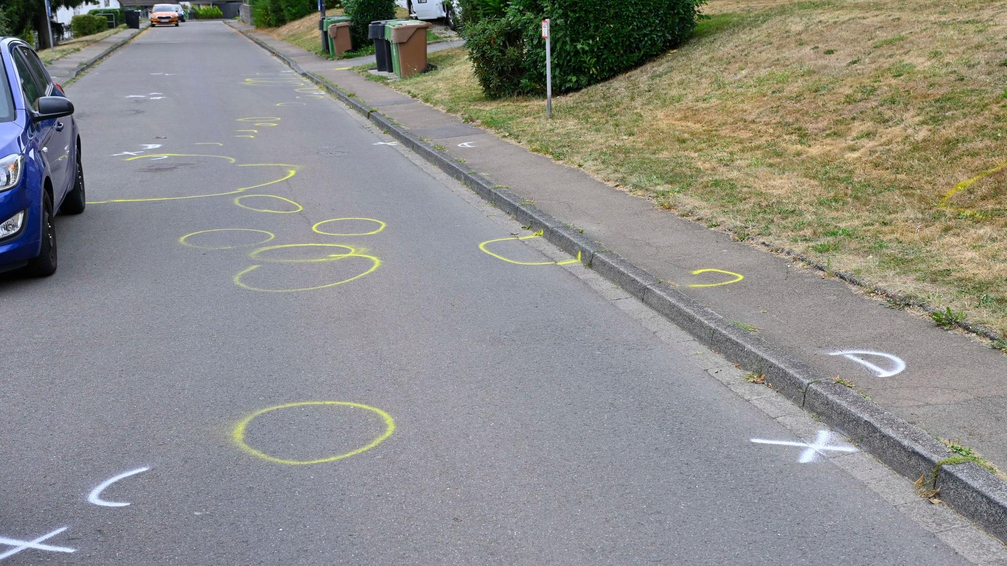 Auf einer Straße sind Markierungen der Polizei zu sehen.