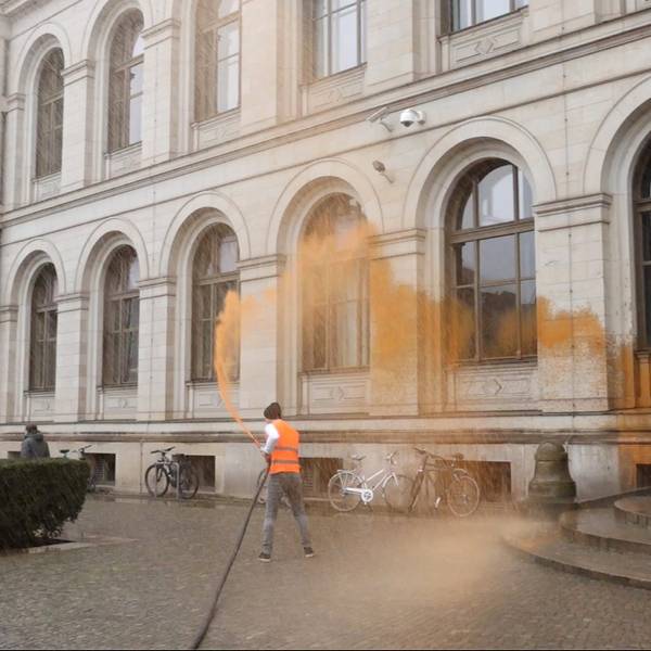 Ein Aktivist bespritzt das Bundesverkehrsministerium.