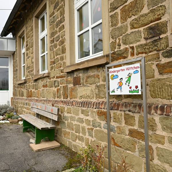 Das Gebäude des Kindergarten St. Mariä Himmelfahrt in Odenthal-Hüttchen. Davor eine Holzbank.