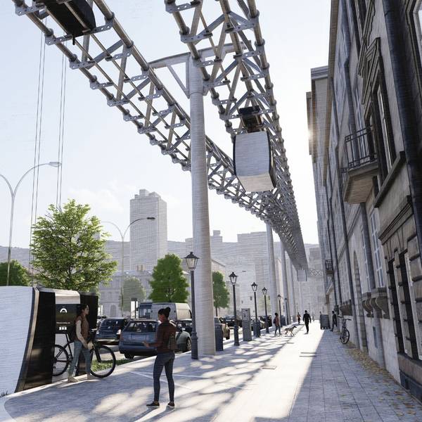 Die Gondel einer Schwebebahn ist am Boden, das Gerüst der Bahn läuft über dem Fußgängerweg her.