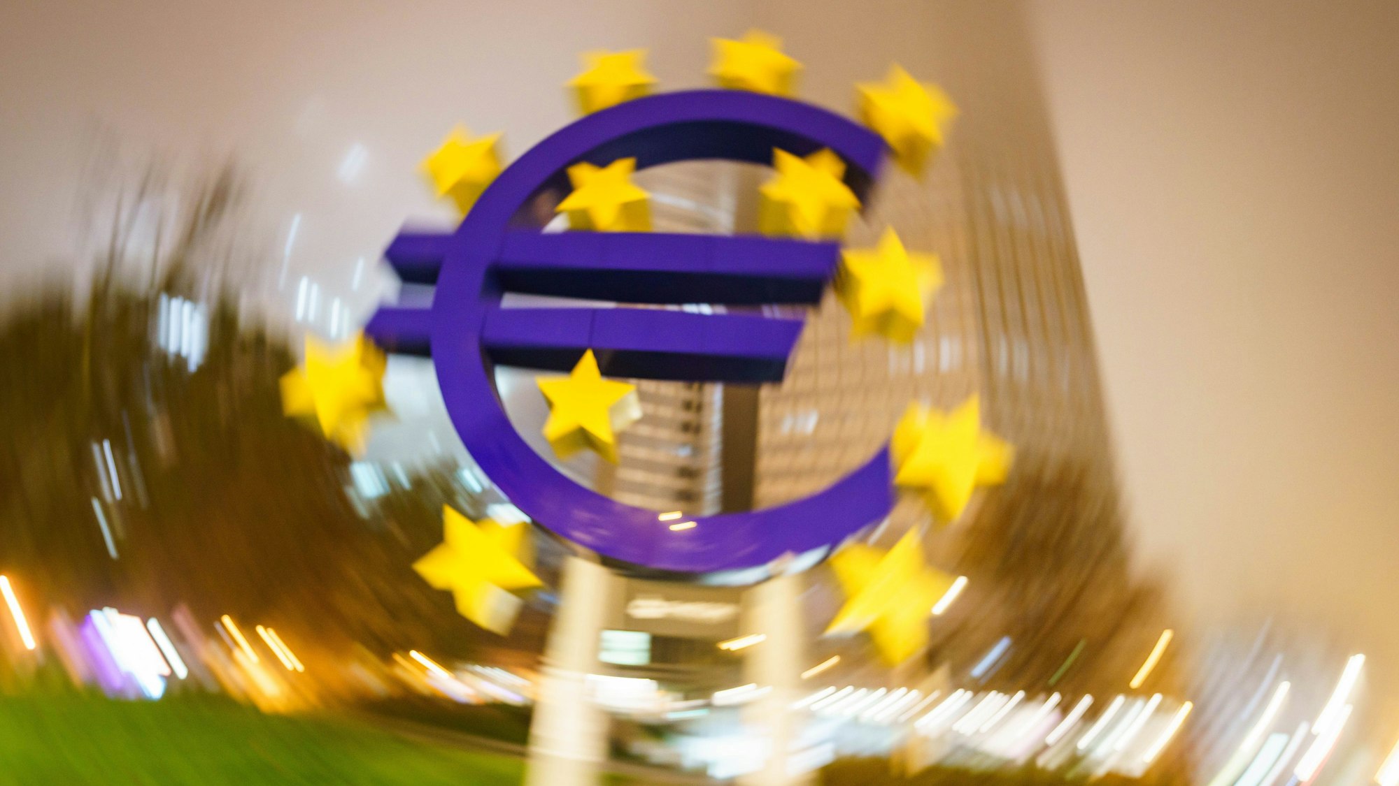 Man sieht das Euro-Denkmal im Zentrum, das Bild außenrum verschwimmt.