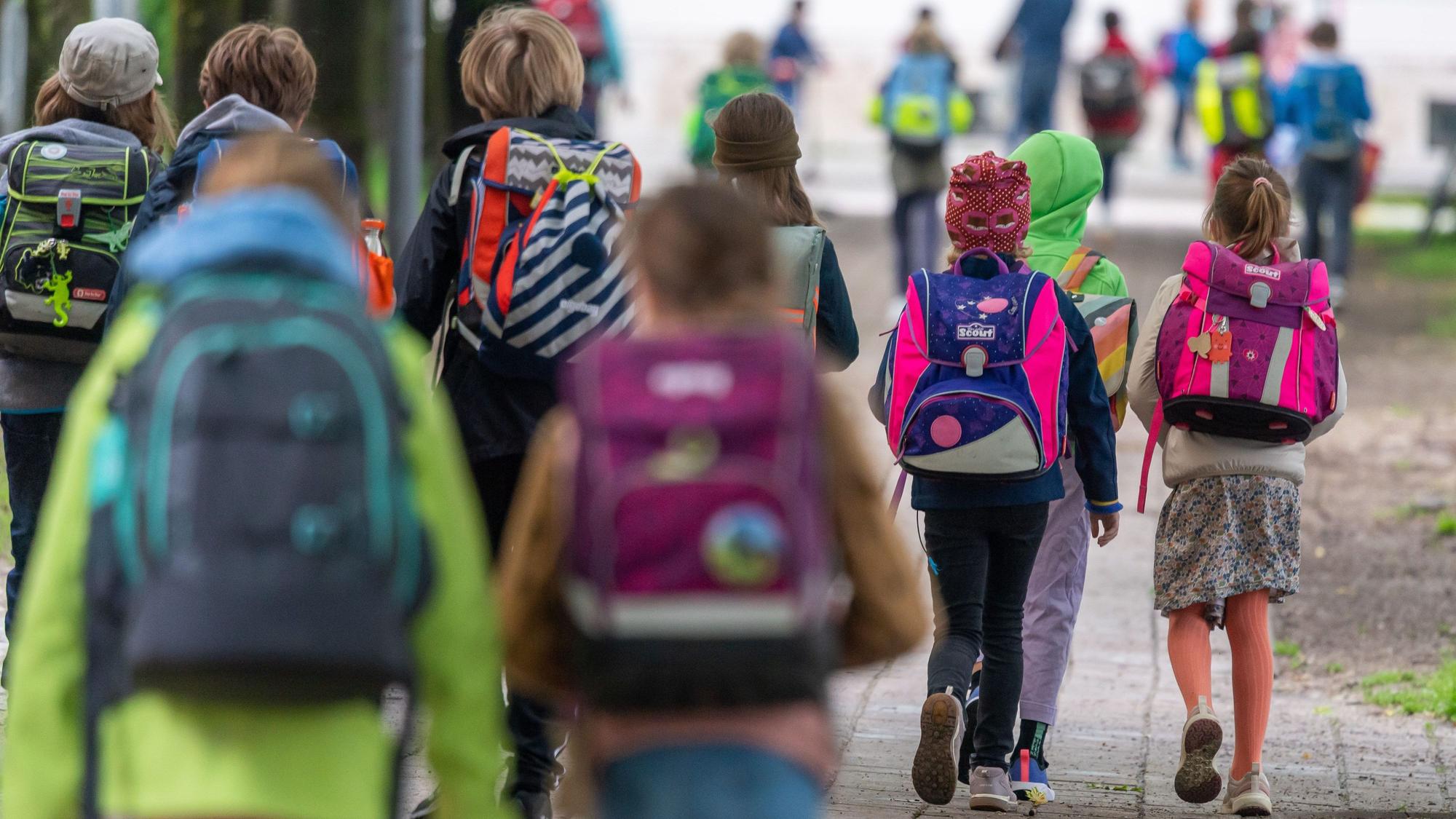 ARCHIV - 07.06.2021, Bayern, München: Schulkinder gehen am Montagmorgen nach den Pfingstferien wieder in die Schule. Bayerns Kommunen haben die verfügbaren Fördergelder des Bundes für den Ausbau der Ganztagsbetreuung für Grundschulkinder zum überwiegendenden Teil nicht abberufen. (zu lby: «Bayerns Kommunen verzichten auf Millionenförderung für Ganztagsausbau») Foto: Peter Kneffel/dpa +++ dpa-Bildfunk +++