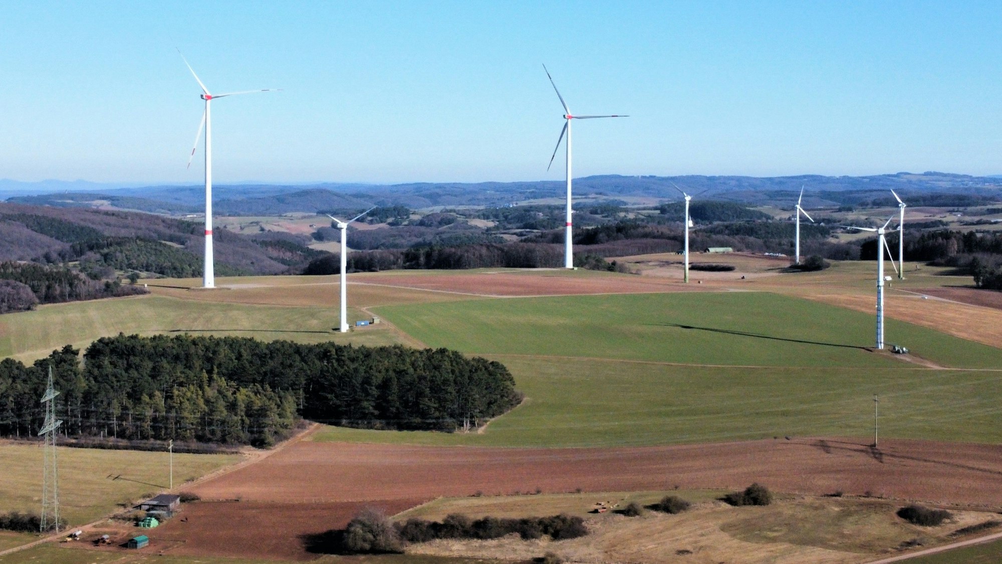 Die Drohnenaufnahme zeigt die derzeit sieben Windräder des Kaller Windparks Ravelsberg