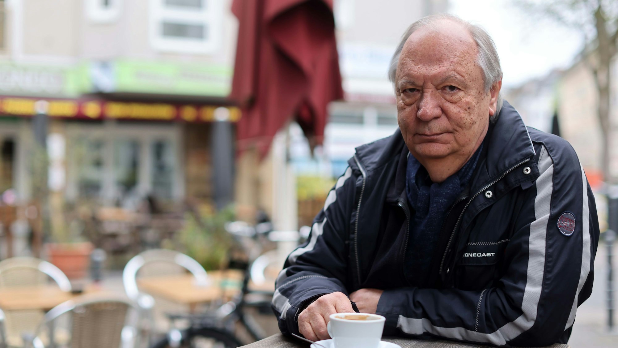 Wilfried Schmickler sitzt in einem Cafe in Köln