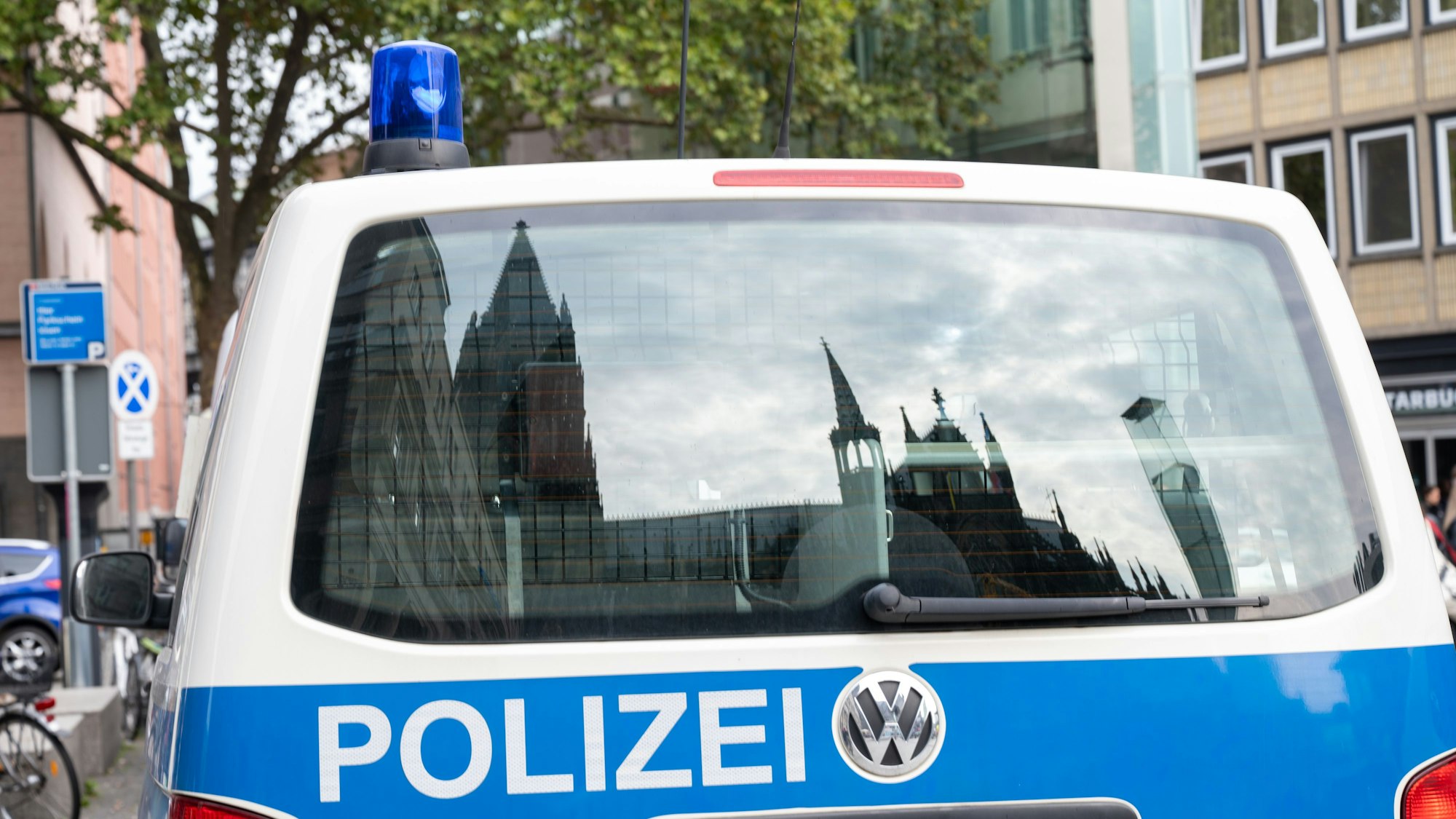 Der Dom spiegelt sich in einem Fenster eines Polizeifahrzeuges. (Symbolbild)